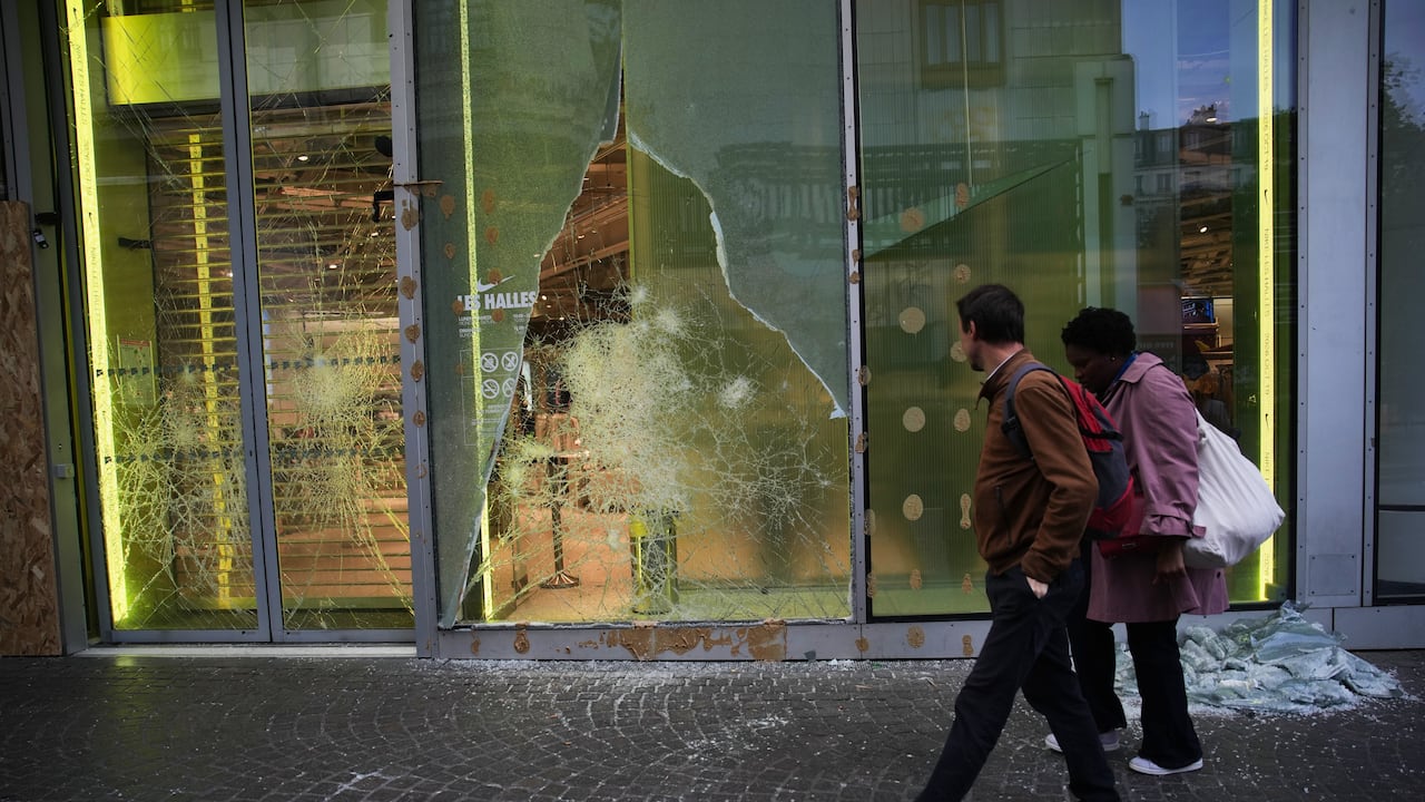 People walk past a looted store, after violence erupted during nationwide protests against rising living costs and poor conditions in schools, in Paris, Monday, Oct. 19, 2026. (AP Photo/Christophe Ena)